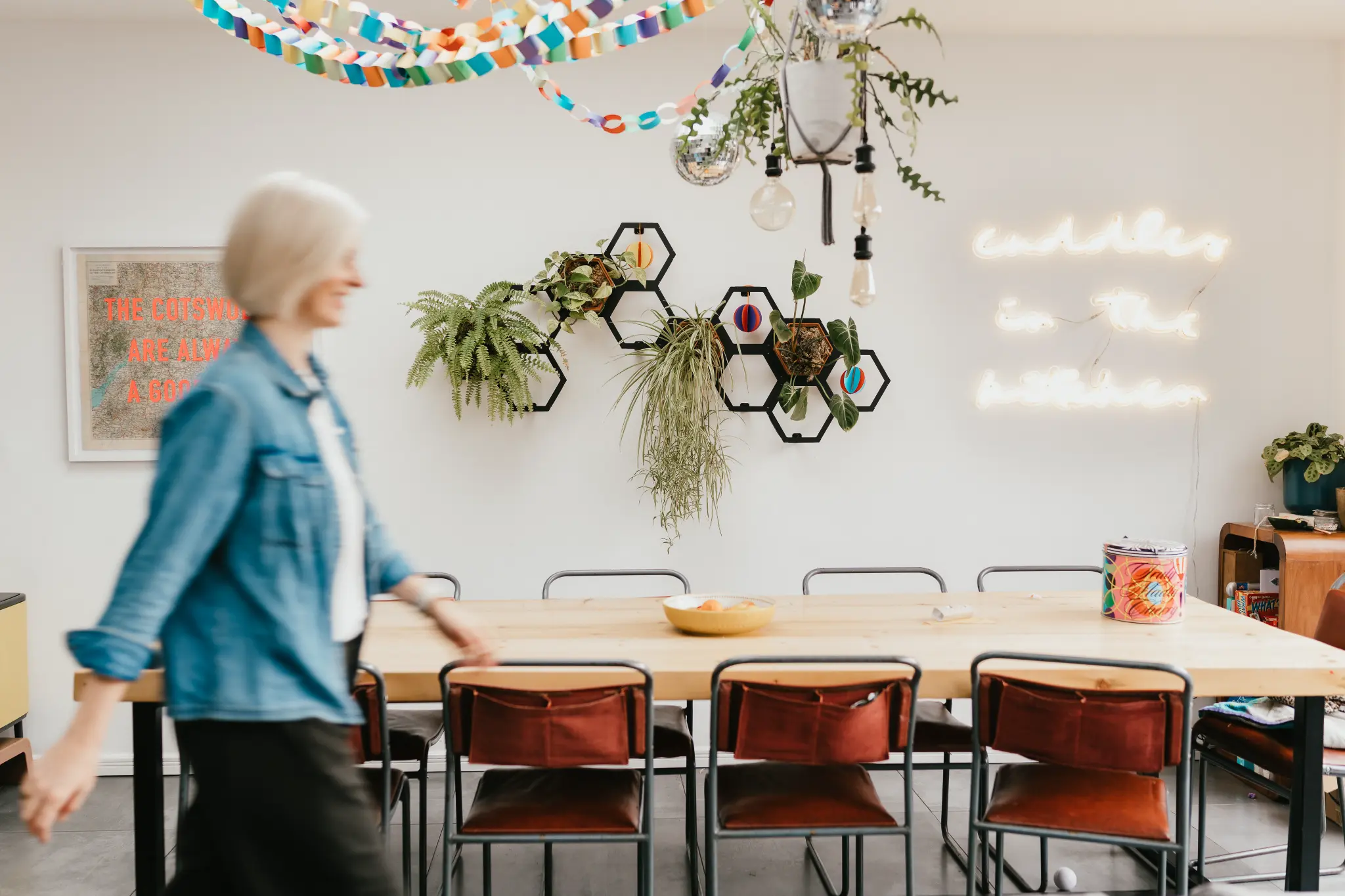 Lucy Nash laughing in a colourful kitchen with paper chains